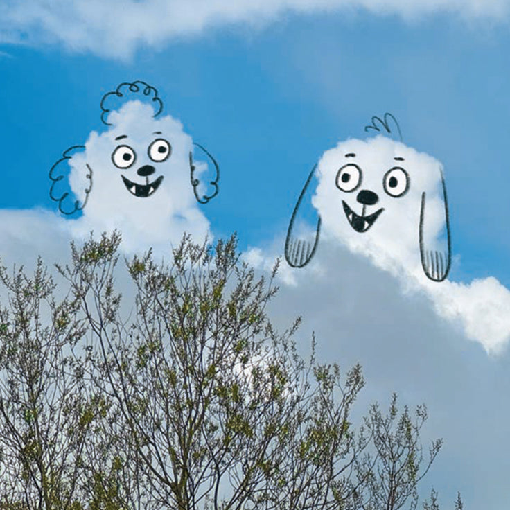 Dog faces made of smoke or steam against a blue sky with trees below.